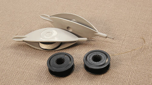 Two Pony bobbin tatting shuttles with built-in hooks, shown with one mounted bobbin, one removed bobbin, and an extra spare bobbin.