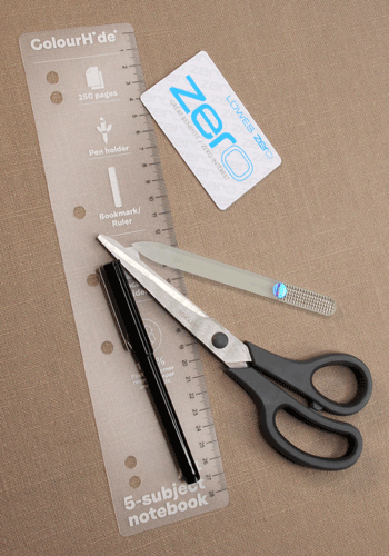 Supplies for DIY tatting shuttle: old plastic card, scissors, ruler, and fine marker
